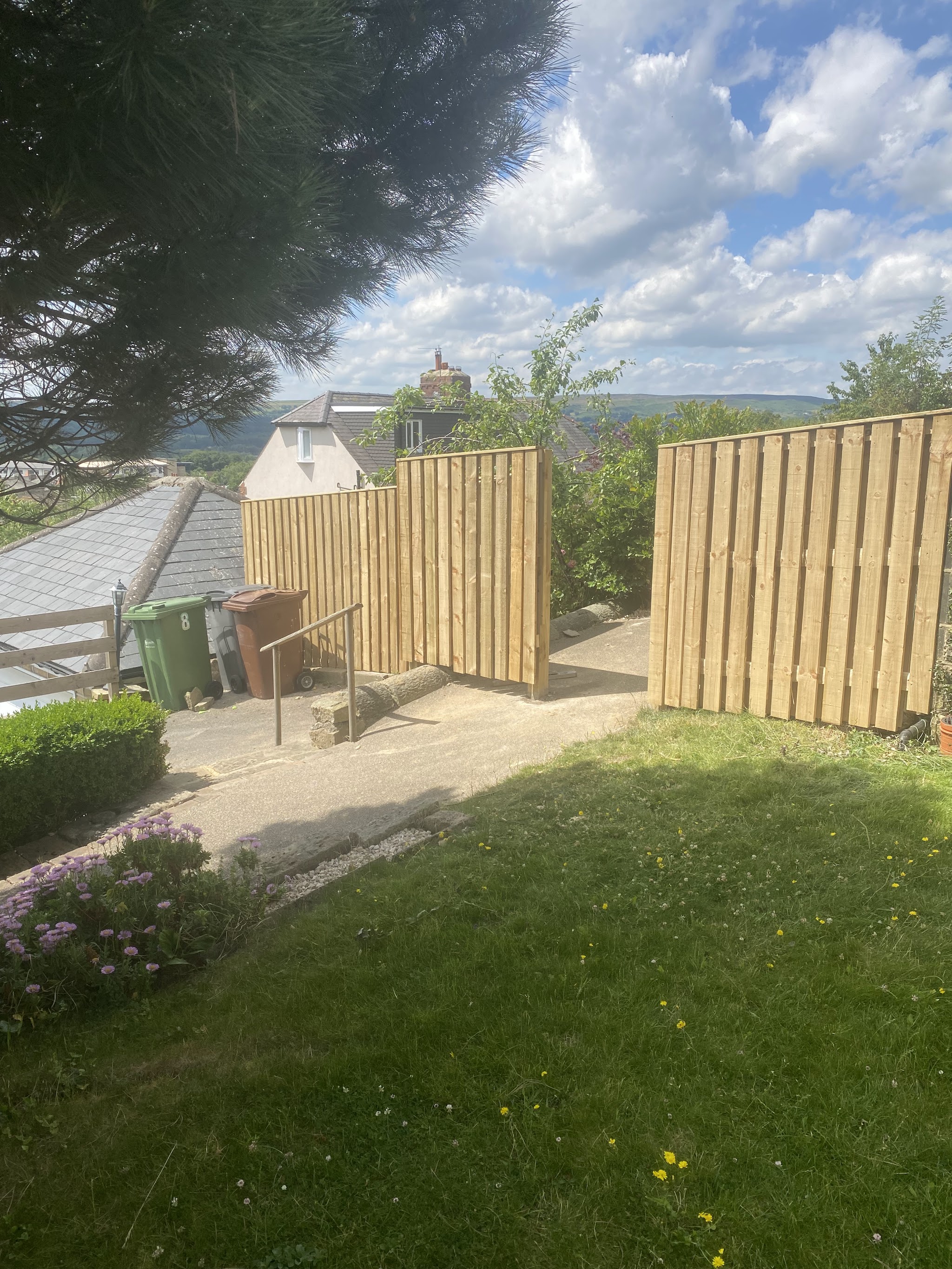 Timber garden fencing with a matching gate and stone pathway